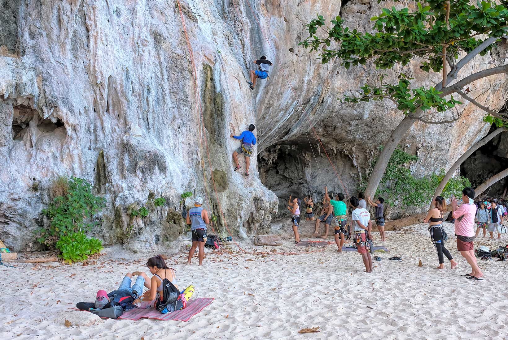 Rock climbers tackle the challenging limestone towers on the eastern side of Railay Beach