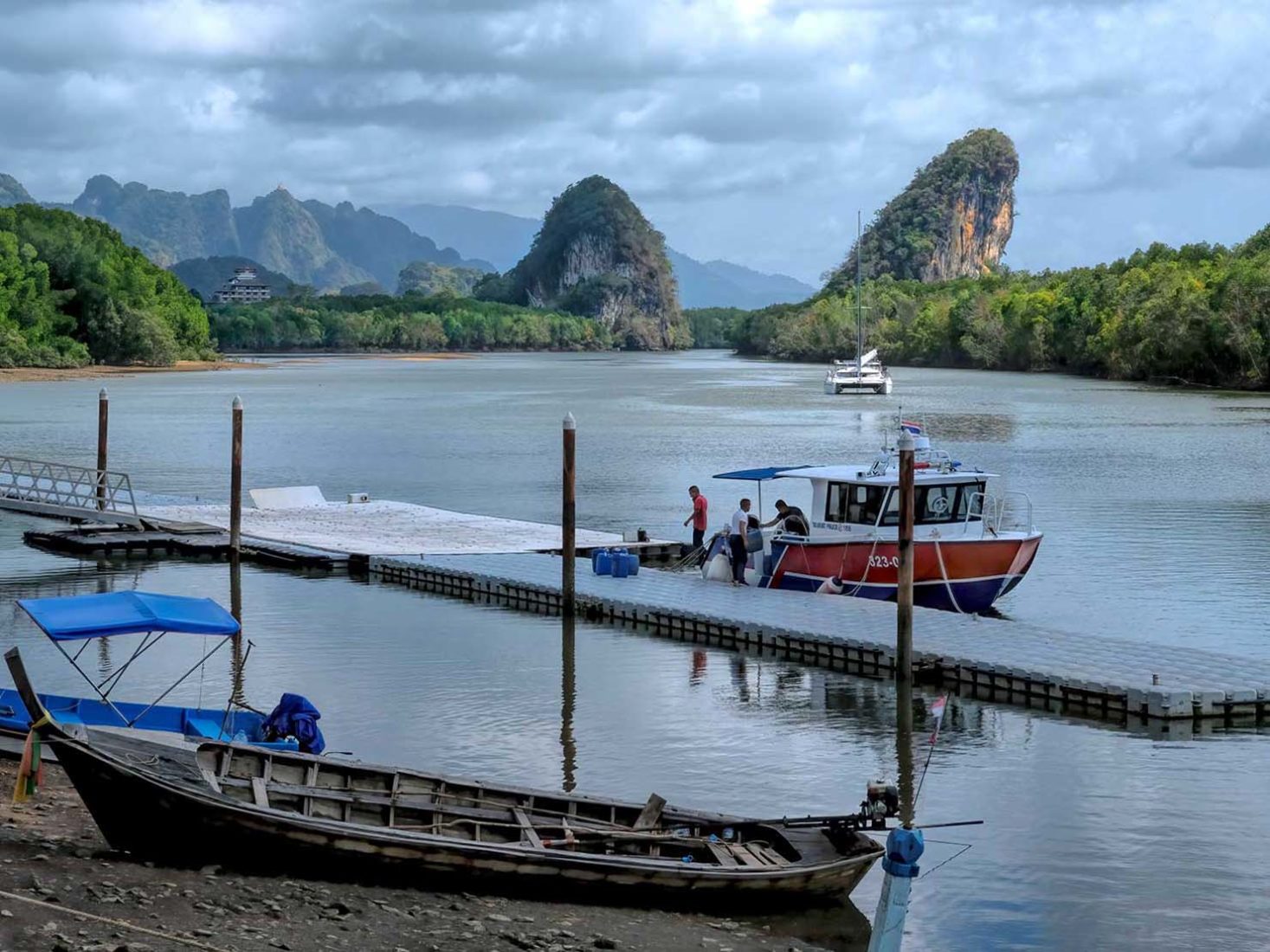 Twin Karst limestone stacks known as Khao Khanap Nam, bracket the Krabi River just north of the city center