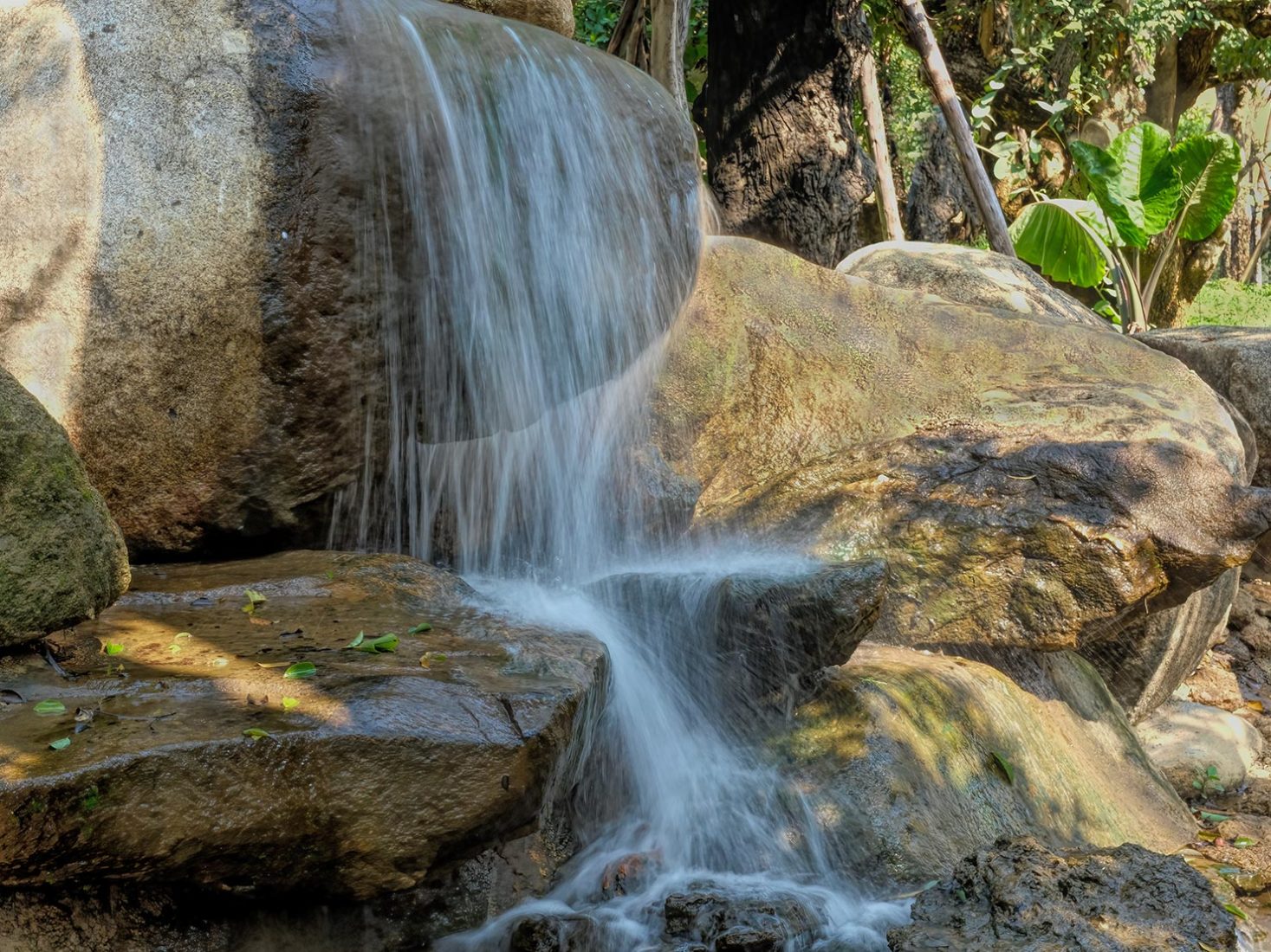 Mini-waterfalls cascade over giant boulders at Dantewada Land of Angels Waterfall Park