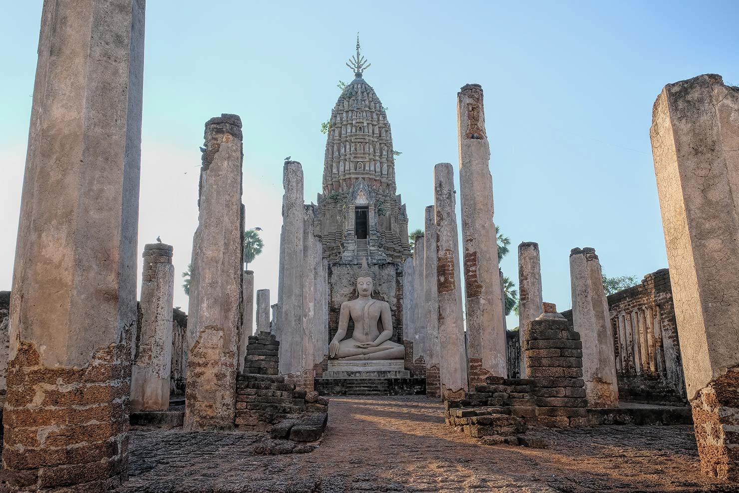 Thailand Si Satchanalai Historical Park Wat Phra Si Ratanamahathat Rajvorsvihara with Khmer prang and Buddha icon