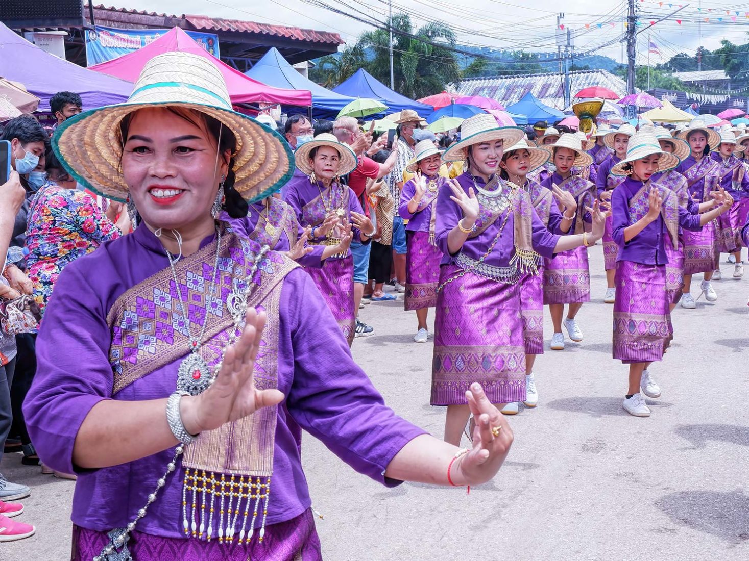 Women perform traditional dances along the parade route
