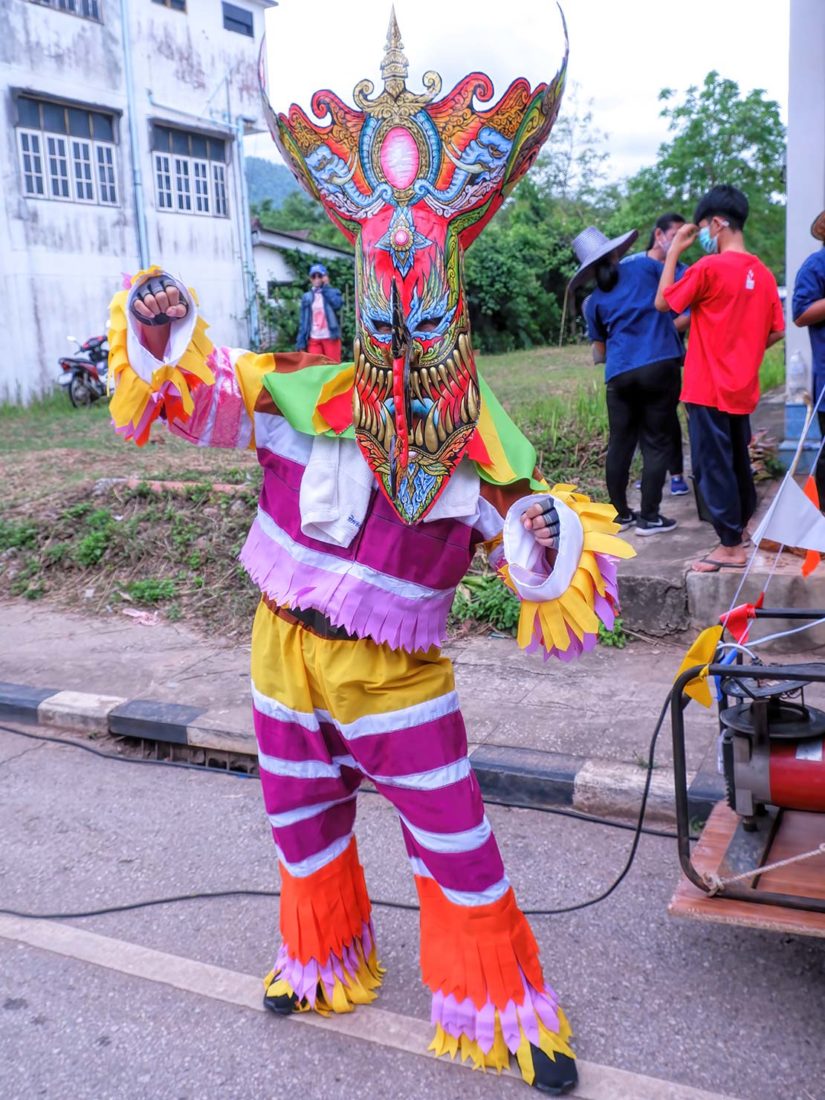 Phi ta Khon Festival participant strikes a menacing pose
