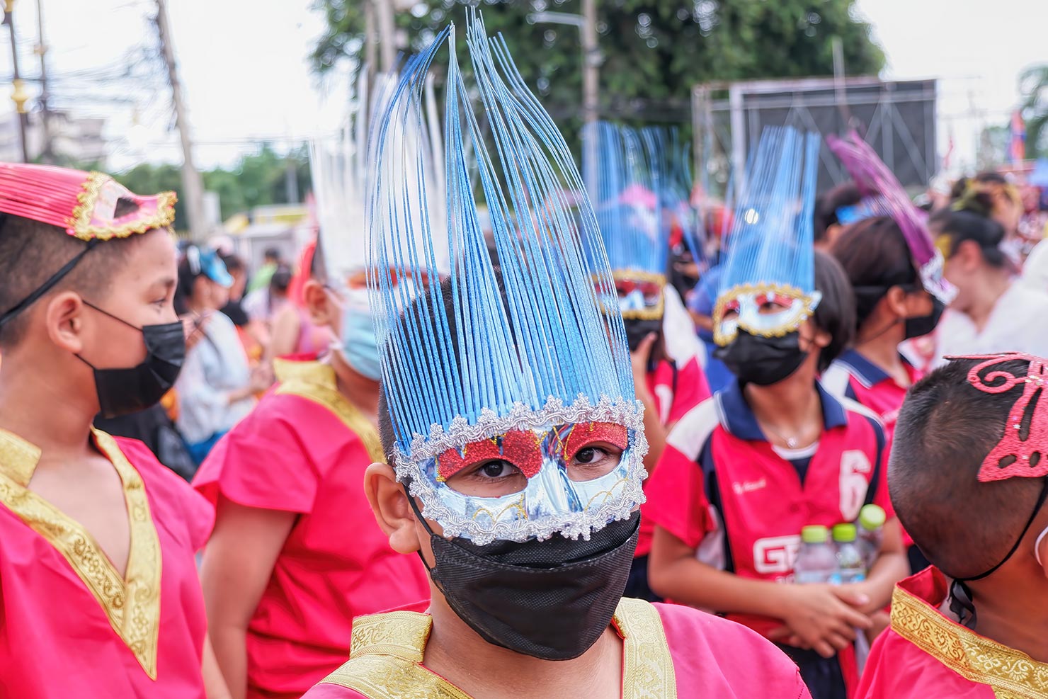 Troupe of young performers don a different kind of mask at the opening ceremony in Loei