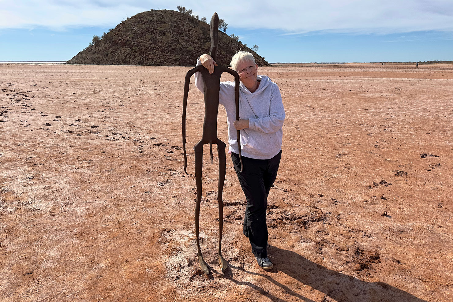 Barbara Weibel poses before an Antony Gormley sculpture on Lake Ballard in Menzies Western Australia