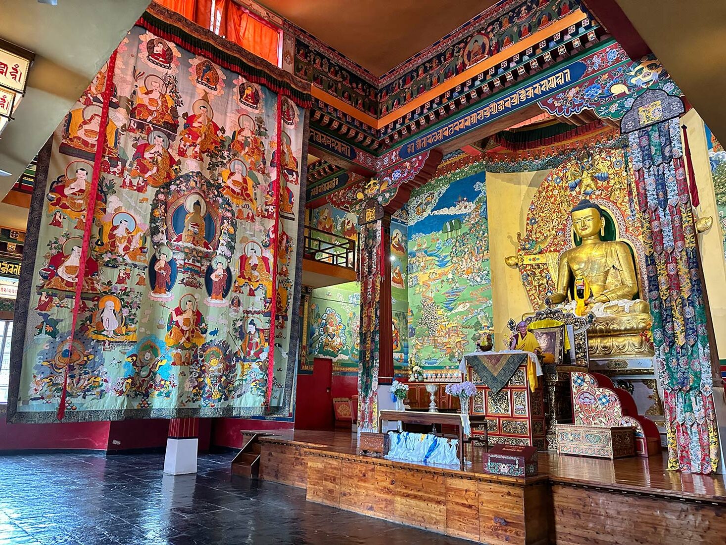 Interior of Deden Tsuklagkhang Temple at the Norbulingka Institute features a 16-foot tall silk and brocade appliquéd depiction of the Sixteen Arhants