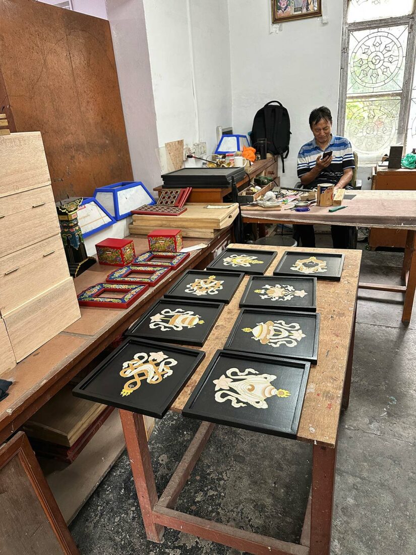 Traditional Tibetan artists create Lacquerware paintings at Norbulingka Institute