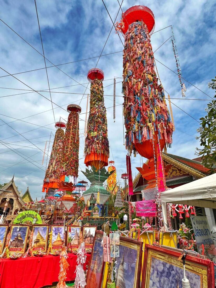 Towers of merit-making gfts dominate the grounds of Wat Haripunchai during the annual Salak Yom Festival in Lamphun Thailand